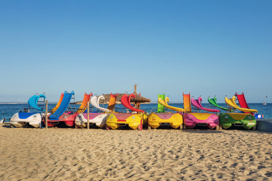 Bright colorful pedal boats with water slides at the beach in Magaluf, Majorca, Spain