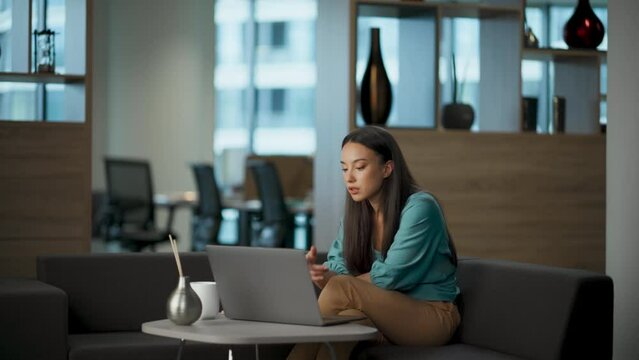 Successful entrepreneur chatting laptop video call lobby. Woman speaking virtual