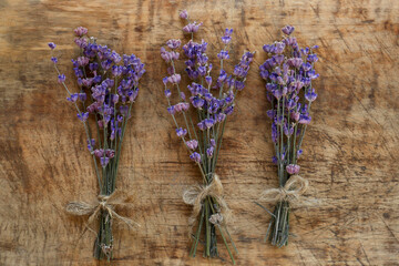 Bouquets of beautiful lavender flowers on wooden table, flat lay