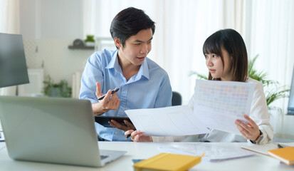 Handsome asian man employee sharing her strategy with her colleagues..