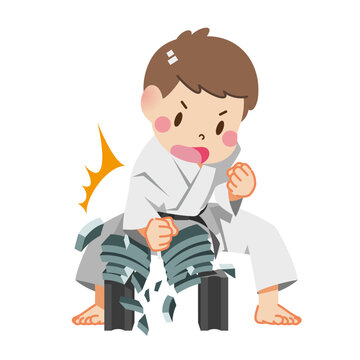 Boy breaking tiles with karate