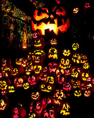 Carved Jack-o-lanterns lit at night for Halloween	