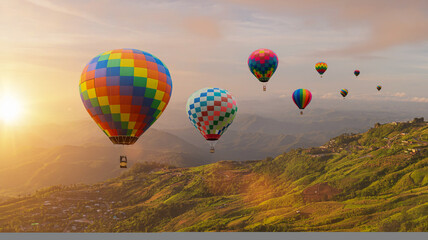 Colorful hot air balloons flying above mountain at sunrise sky background. Travel natural background.