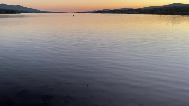 Gently rippling seawater at Kenmare Bay close to sunset.