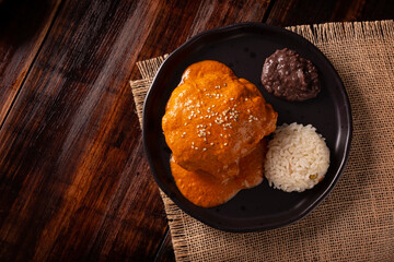 Encacahuatado. Mexican mole made from peanuts, dried chilies, sesame seeds, tomatoes and other spices. It is served bathing pieces of beef, pork or chicken or in Enmoladas.