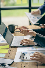 close-up group of business people with financial graphs and money pens An accountant holding a pen pointing to a chart of documents for a team meeting in the office Finance and Accounting Concepts ver