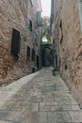 Narrow alley of a medieval town in Tuscany, Italy