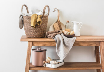 Laundry home interior with accessories for cleaning, washing, cleanliness on a wooden bench