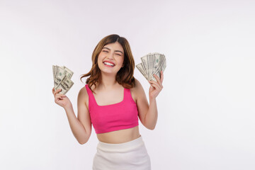 Portrait of excited young woman holding bunch of dollars banknotes isolated over white background