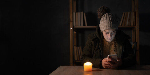 Young woman suffers in no heating and no electricity during an energy crisis in Europe causing...