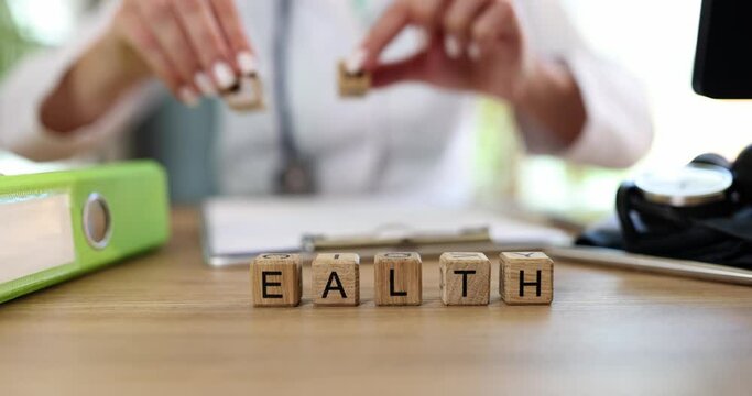 Doctor nurse changes letters in word health and wealth on cubes
