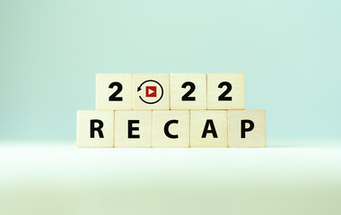 2022 Recap economy, business, financial concept. Business plan in 2023. RECAP words and 2022 on wooden cubes on smart grey background and copy space.