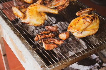 Close up shot of chicken grilled on charcoal for BBQ dinner 