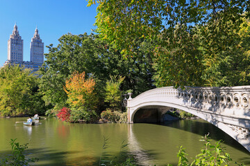 Central Park in foliage autumn colors, including the lake, boats and bridge in New York City, USA