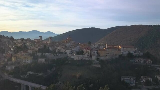 Aerial slow movement around medieval village of Arcevia surrounded by buildings