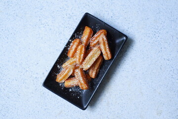 a plate of churros in white background 