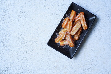 a plate of churros in white background 