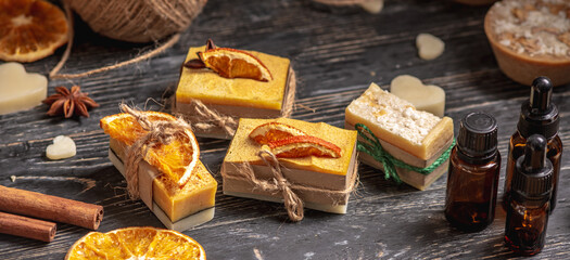 Beautiful natural soap decorated with a slice of orange and star anise. Concept of handmade organic gifts, a useful hobby, a festive atmosphere