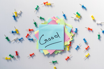 Good word handwritten on a sticy note