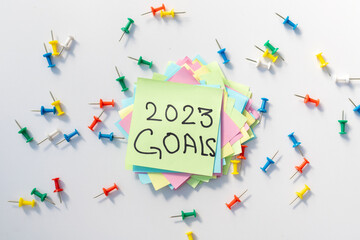 2023 goals hand written on a yellow notepad page with isolated white background