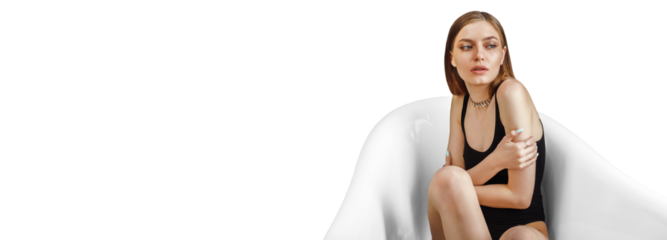 Young woman shivering with cold in the bath, the water is turned off, embracing her shoulders. Concept of energy crisis