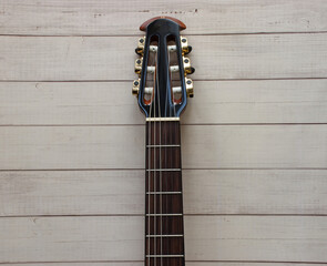 Acoustic guitar fretboard on wooden background. Space for text.