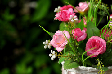 Plastic flower arrangements of various colors in pots