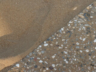 Diagonal border between sand and stones