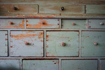 Old sideboard, old worn sideboard in light blue with many drawers and chipped paint.