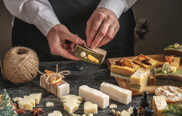 Woman is wrapping a beautiful natural soap. Concept of handmade organic gifts, useful hobby, festive atmosphere