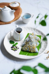 a plate of lupis, traditional cake made from sticky rice served with brown sugar syrup