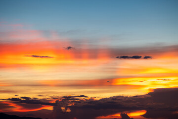 Fototapeta premium The dramatic colors of the sunset in the sky gradient from blue to orange.