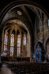 Fototapeta na wymiar Interior, cross ribbed vault and stained glass of the gothic Saint Etienne collegiate church of Capestang, in the South of France (Herault)