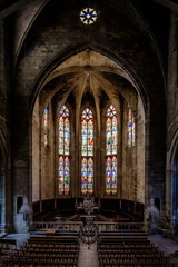 Fototapeta na wymiar Interior, cross ribbed vault and stained glass of the gothic Saint Etienne collegiate church of Capestang, in the South of France (Herault)