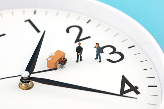 Miniature creative businessman meditating on dial
