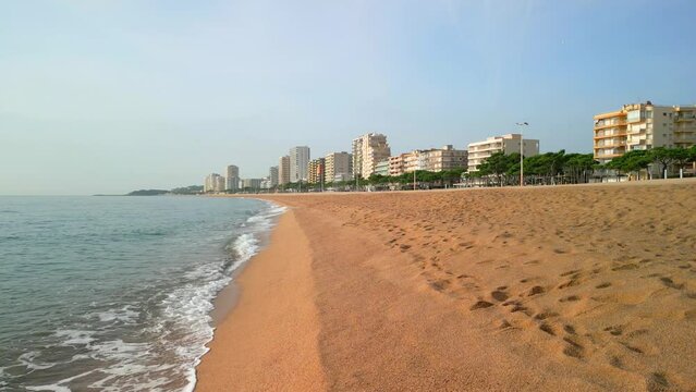 Walk along the hoop plant beach on the Costa Brava in Girona without people small waves