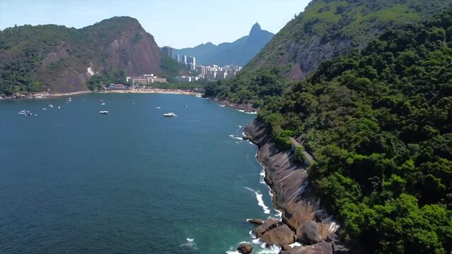 Sugarloaf Mountain Cliffside view panning to tropical Red Beach Brazil (Praia vermelha), Blue Waters And Mega Yachts 
Rio de Janeiro, Brazil by Drone 4k
Aerial Nature + Travel