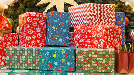 Christmas gift boxes wrapped in colorful paper, close-up, front view.