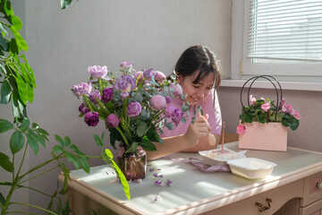 smiling girl eating cake sitting at the table