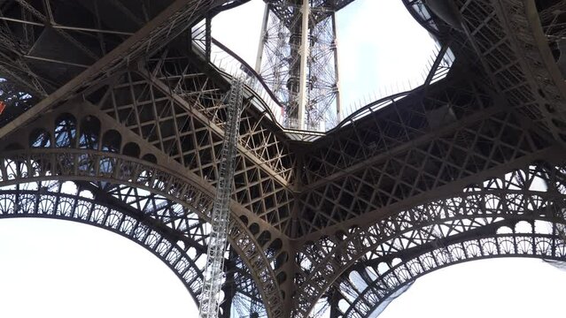 Looking Up The Architecture View From The Inner Base Of The Eiffel Tower In Paris, France. - Low-Angle Shot