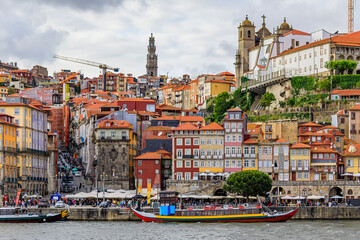 Fototapeta na wymiar Traditional Portuguese houses in Ribeira, rabelo boats on Douro, Porto, Portugal