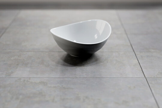 White Empty Porcelain Cereal Bowl On Organic Tile Surface.