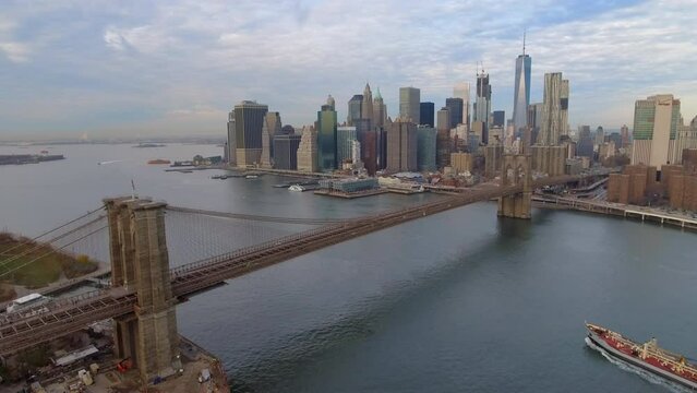 Aerial Panning Shot Of Famous Brooklyn Bridge Over East River By Skyscrapers In Modern City - New York, New York