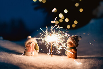 Sparkler in the snow in the evening.