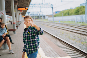 little boy waiting for train. Father and son waiting at platform