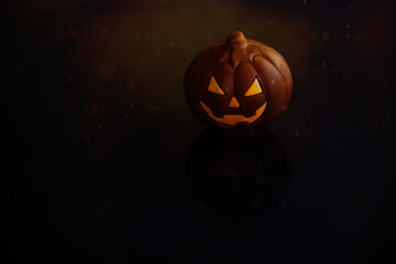  chocolate halloween pumpkin jack-o-lantern on dark background
