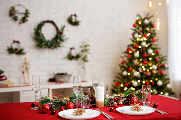 Served table for christmas dinner in decorated living room