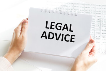 Legal advice inscription on a notebook in the hands of a businessman on the background of an office desk