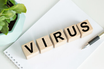VIRUS text and symbols is written on wooden cubes as pandemic concept