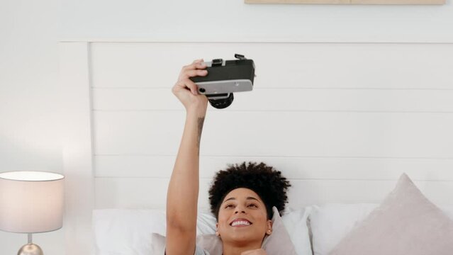 Camera, pouting and woman with a photo on a bed in a house to relax and film in the morning. Young, happy and funny girl with a picture of her face on a retro and vintage camera in the bedroom